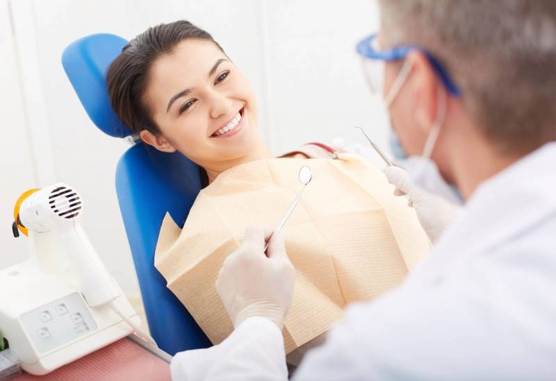 Smiling patient looking at the dentist